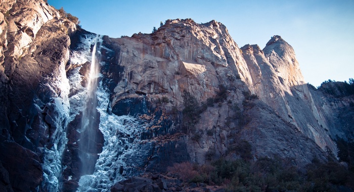 Waterfall cascading down a rocky mountain face