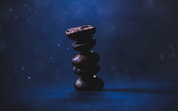 Stack of coffee beans with water droplets