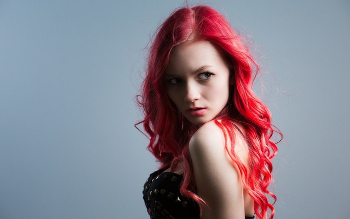 Woman with long, curly, red dyed hair