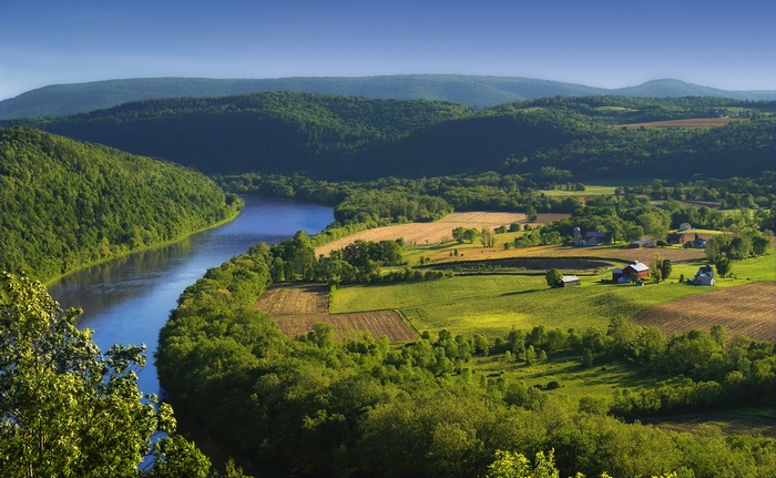River valley with farms and rolling green hills