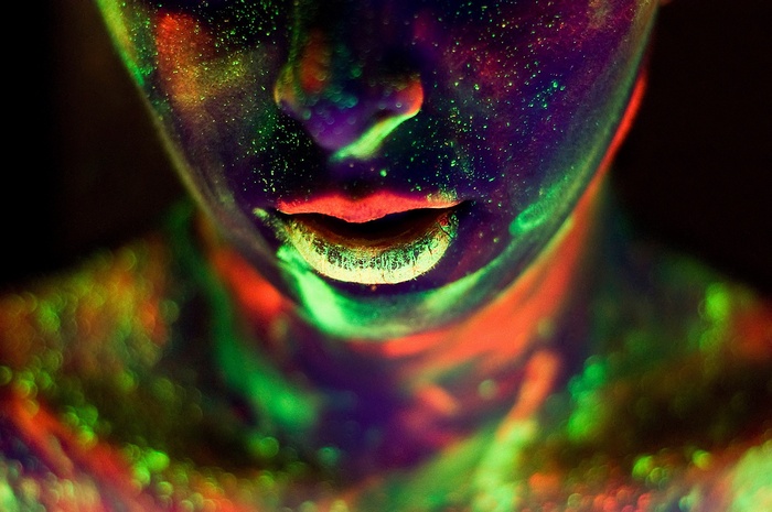Close-up of face with neon body paint and braces
