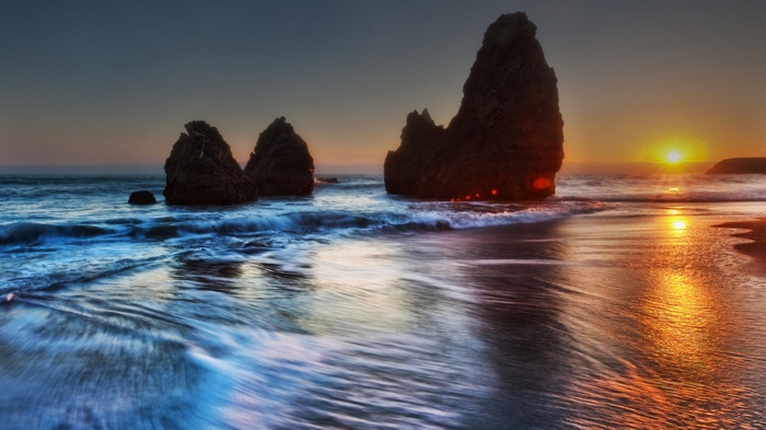Sunset over the ocean with rock formations