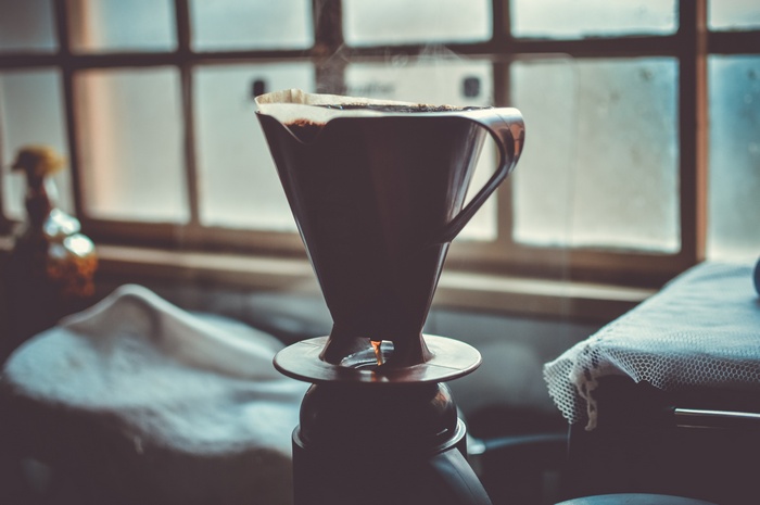 Pour-over coffee brewing in a dark room