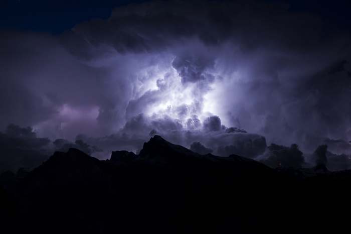 Lightning storm over dark mountains