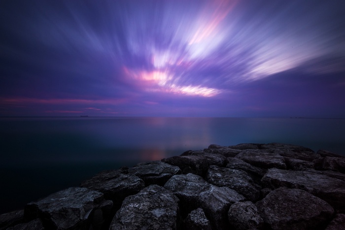 Long exposure of clouds over the sea at dusk