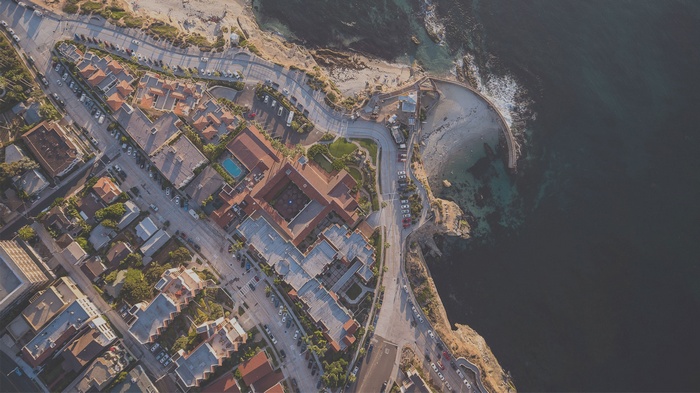 Aerial view of a coastal town with a beach and ocean