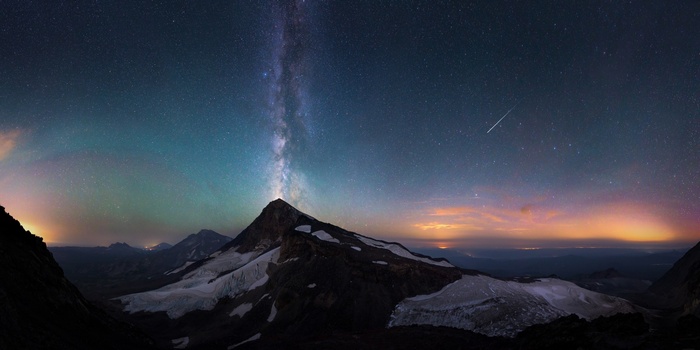 Milky Way over snow-capped mountains at night