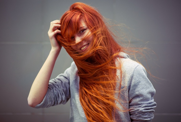 Redhead woman with long hair smiling