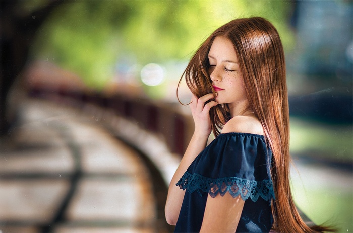 Redhead girl with freckles and long hair