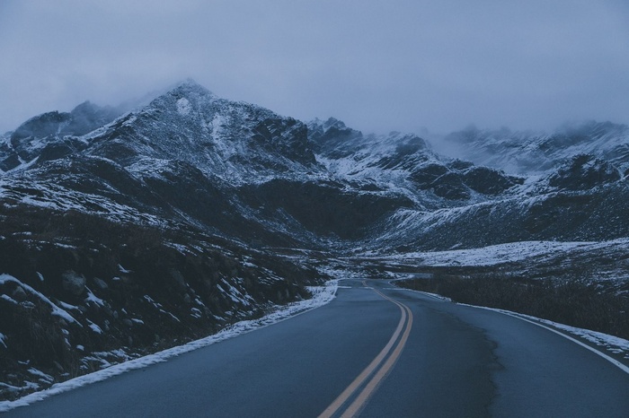 Winding mountain road in a snowy landscape