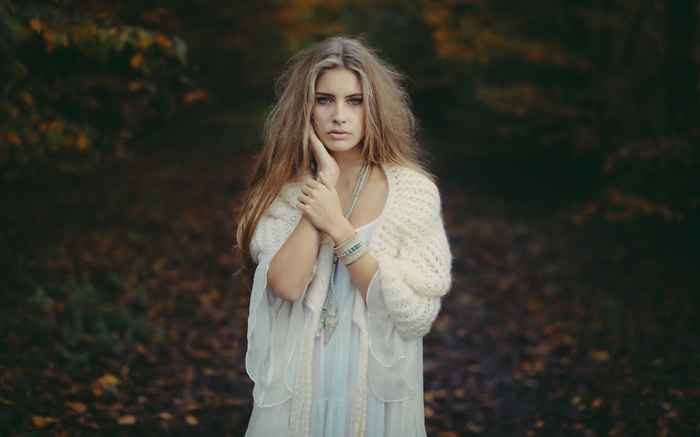 Camille Rochette in a white shawl and dress outdoors
