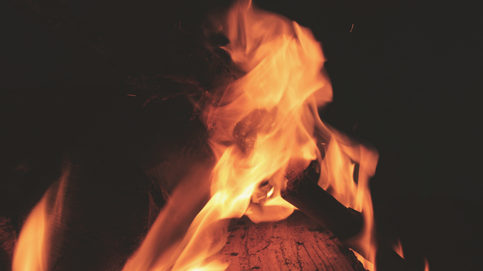 Close-up of a bonfire with flames and logs