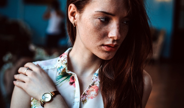 Woman with freckles wearing a floral shirt