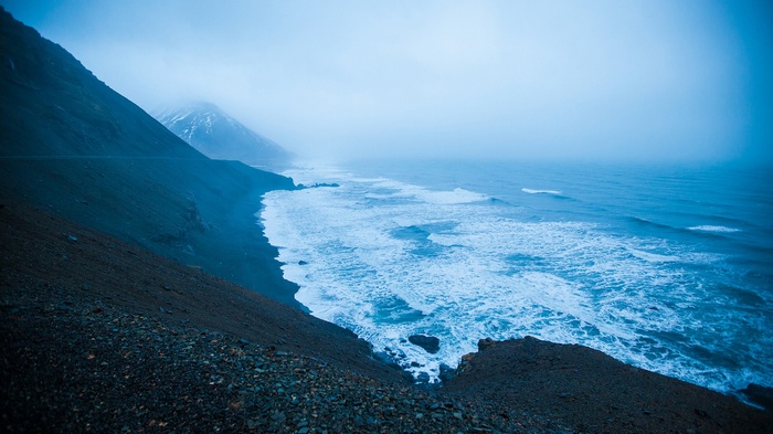 Misty Coastline with Crashing Waves