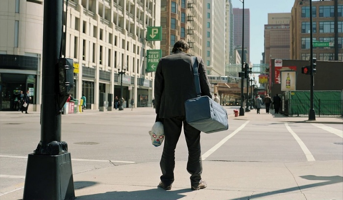 The Joker holding a mask in The Dark Knight