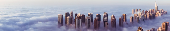 Dubai skyscrapers emerge from clouds in a panoramic view