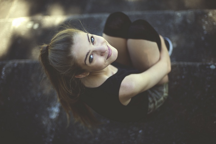 Woman with ponytail sitting on stairs