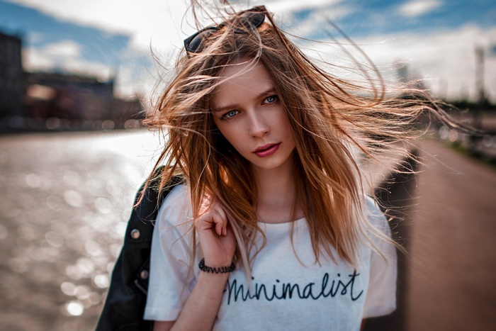 Woman with windblown hair in an urban setting