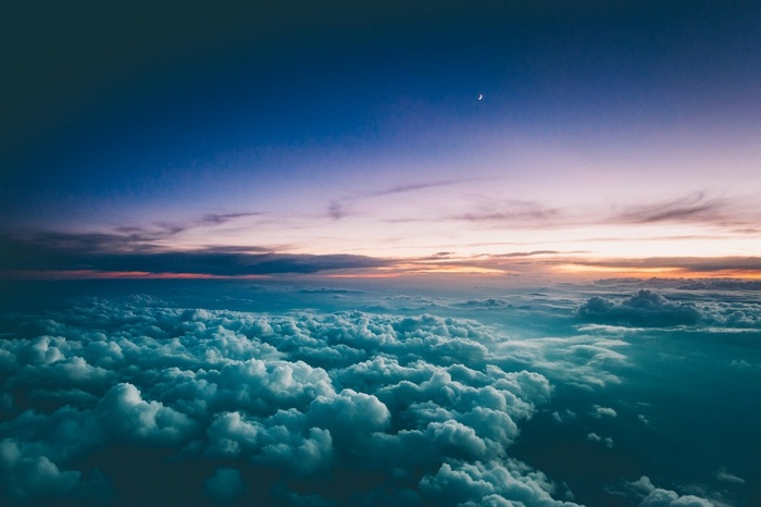 Clouds and sky at sunset with a crescent moon