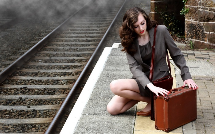 Woman with suitcase at train station