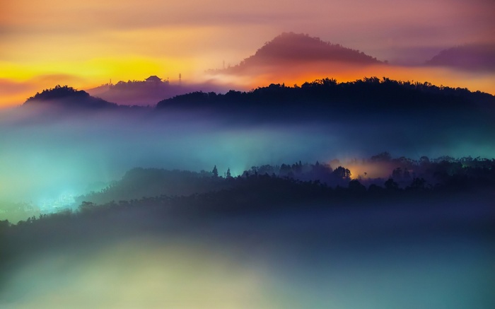 Misty mountains at sunrise with colorful sky