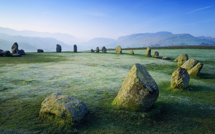 Stone circle on a frosty morning with mountains