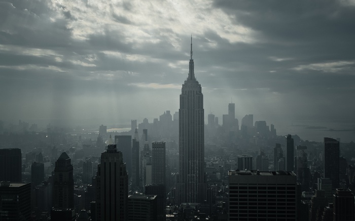 Empire State Building in New York City under cloudy skies