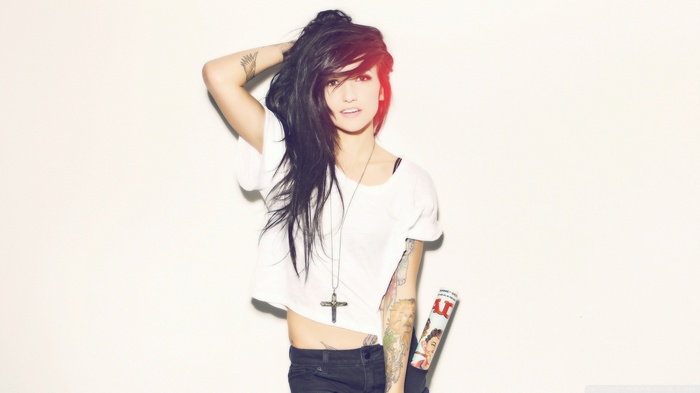 Valerie Poxleitner with tattoos and a cross necklace