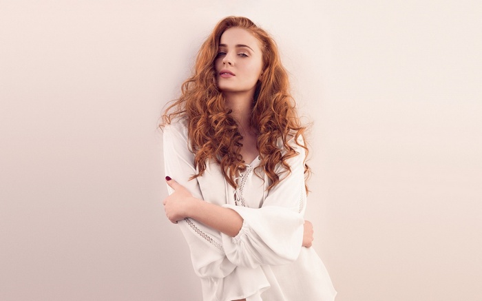 Sophie Turner with long curly red hair