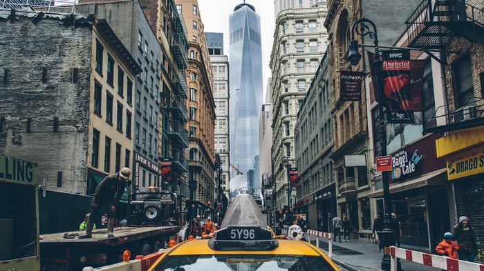 Yellow taxi in New York City with One World Trade Center