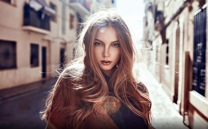 Woman with long blonde hair in a street