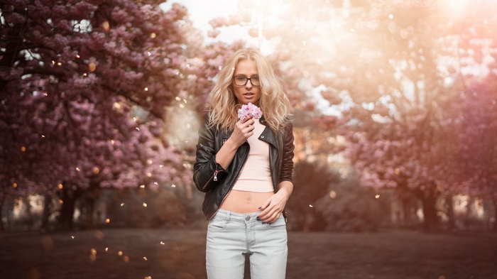 Woman in leather jacket holding a flower
