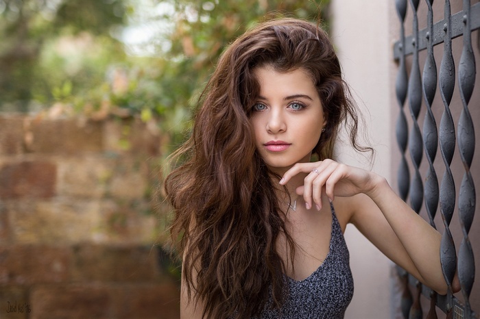 Portrait of a young woman with blue eyes and long brown hair
