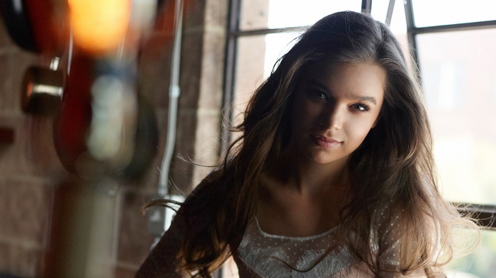 Hailee Steinfeld poses near a window