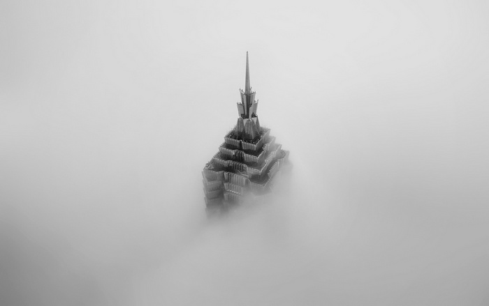 Monochrome skyscraper emerging from fog