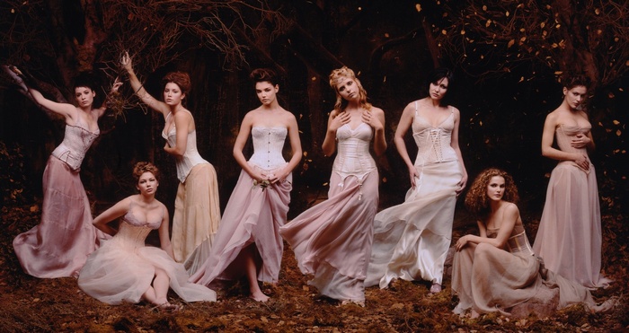 Women in corsets and flowing dresses in a forest