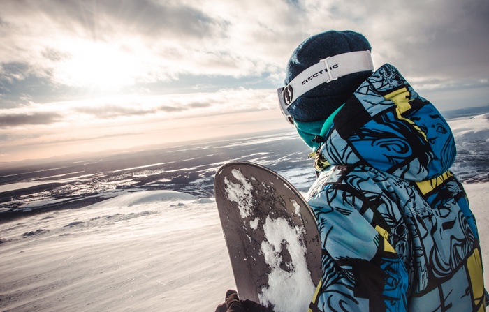 Snowboarder looking out over a snowy landscape