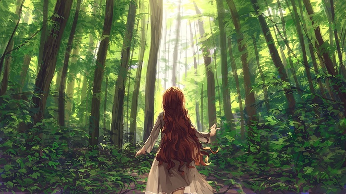 Girl with long red hair in a sunlit forest