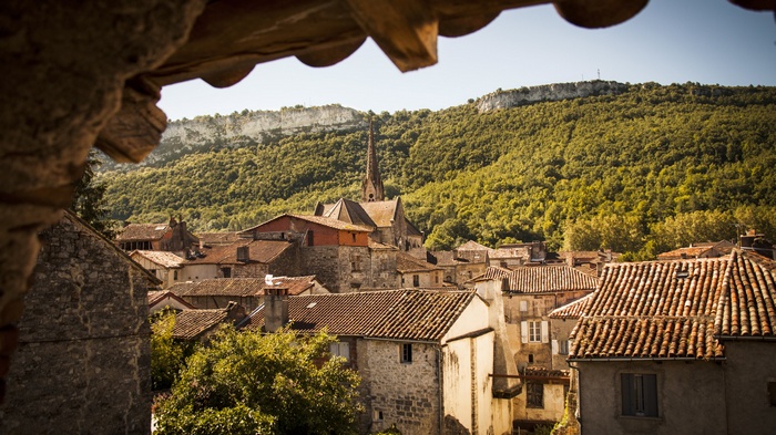 Village with church and forested hills in France
