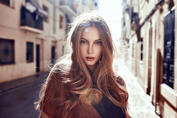 Portrait of a young woman in a European street