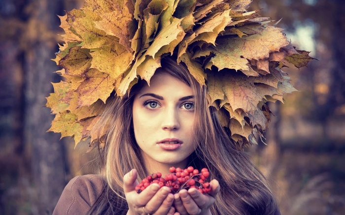 Woman with autumn leaves crown and berries