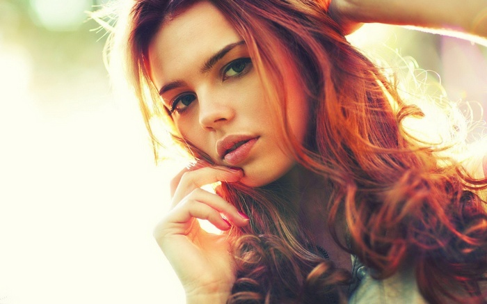 Darya Lebedeva with flowing red hair in sunlight