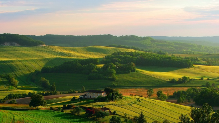 Rolling hills and farmland in Italy at sunset