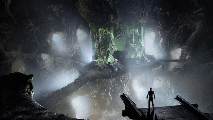Alien creatures in containment pods in a dark cave