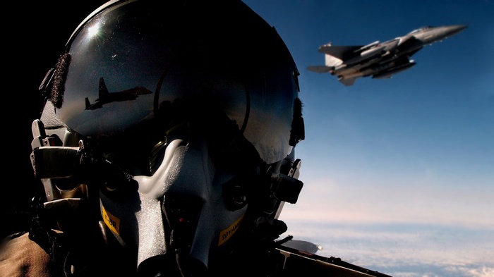 Pilot in helmet with F-15 Eagle reflection