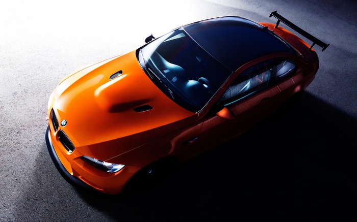 Orange BMW M3 sports car with a rear spoiler
