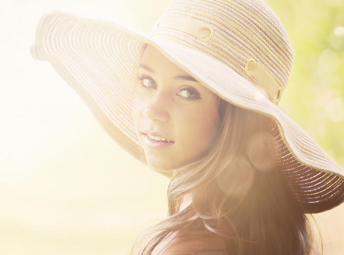 Woman wearing a wide-brimmed hat in sunlight