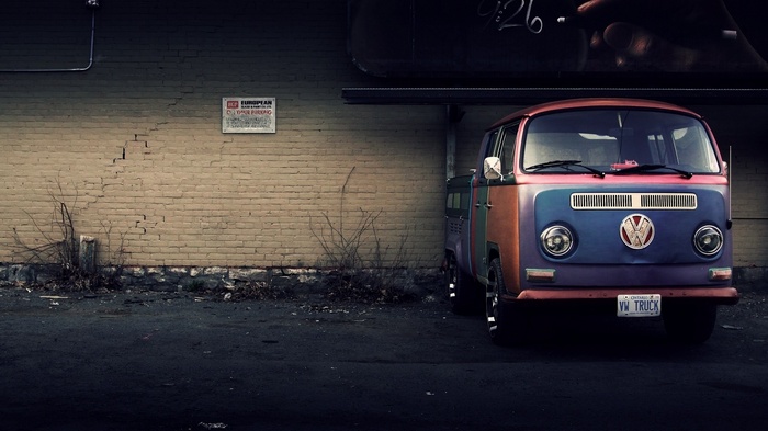 Colorful Volkswagen Truck parked by a brick wall