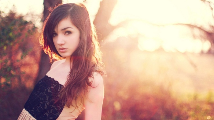 Woman in a strapless dress in sunlight