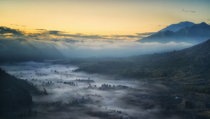 Misty valley and mountains in Indonesia at sunrise